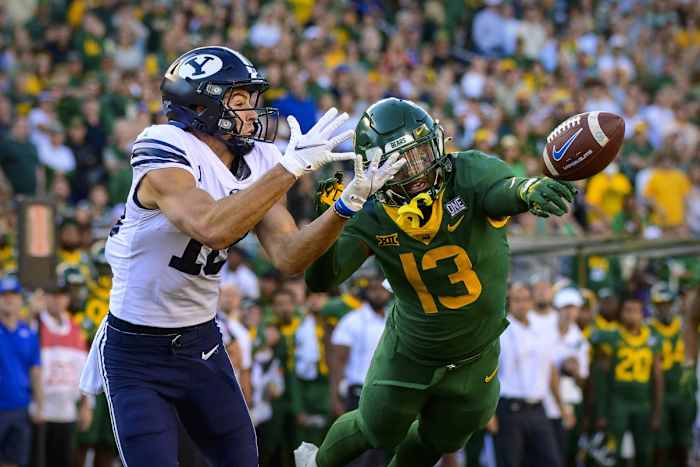 Oct 16, 2021; Waco, Texas, USA; Baylor Bears cornerback Al Walcott (13) breaks up a pass intended for Brigham Young Cougars wide receiver Gunner Romney (18) during the second half at McLane Stadium.
